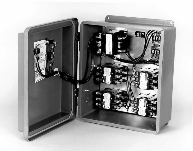 Inside view of an Aitken control assembly showing the contactors, transformer, and pre-wired connections