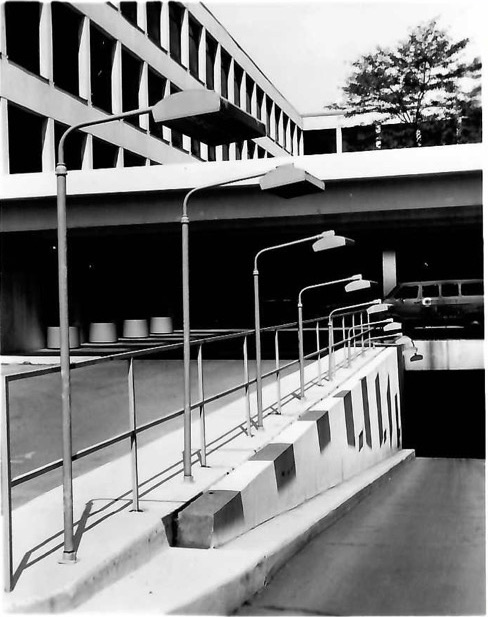 Solarbeam quartz lamp heaters mounted along a parking garage entrance ramp for snow melting